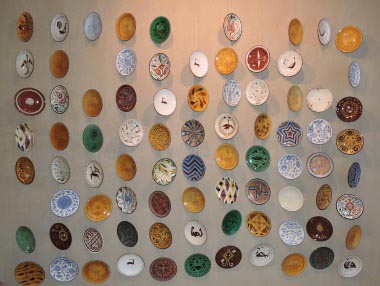 Wall of pottery designs
